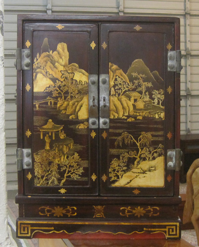 Appraisal: SMALL CHINESE CABINET the double doors decorated with gold landscape