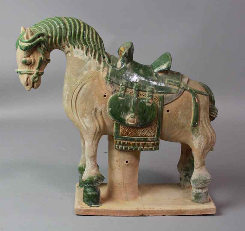 Appraisal: CHINESE SANCAI-GLAZED POTTERY CAPARISIONED HORSE MING DYNASTY the creature standing