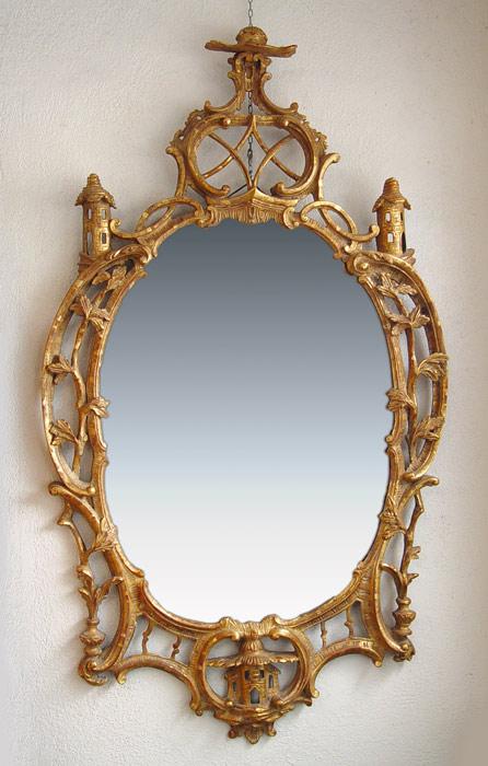 Appraisal: CARVED AND GILTWOOD OVAL MIRROR Scroll and vine frame with