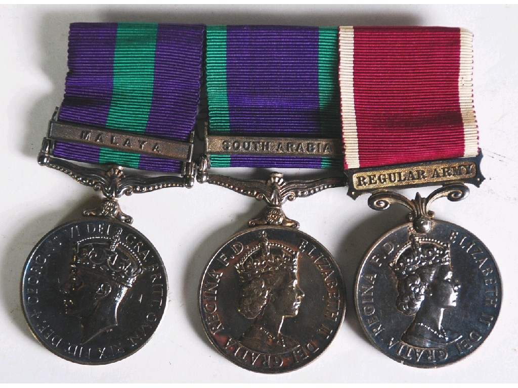 Appraisal: THREE CIRCA 's 's SERVICE MEDALS WITH RIBBONS AWARDED TO