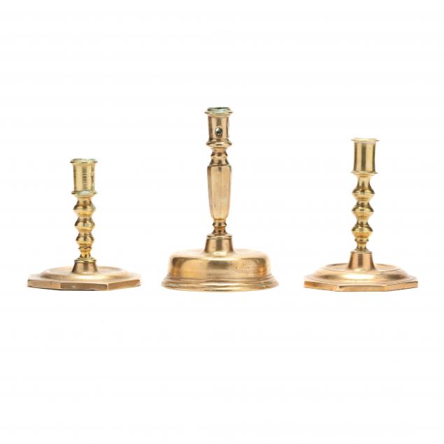 Appraisal: THREE EARLY CONTINENTAL BRASS CANDLESTICKS Circa the first two with