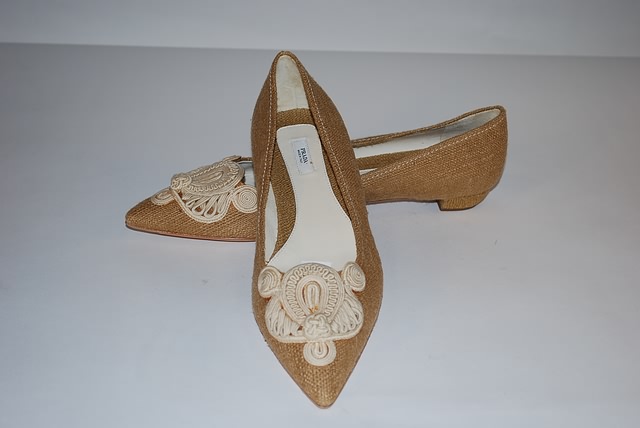 Appraisal: Prada tan leather cloth flat with embroidered woven detail on