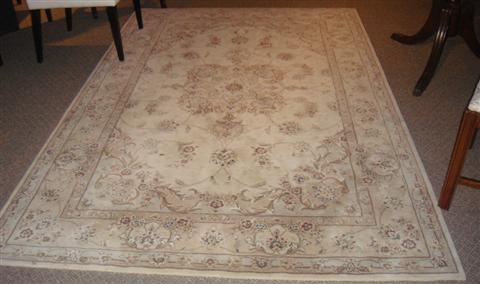 Appraisal: CREAM AND BEIGE FLORAL RUG wool and silk x Feet