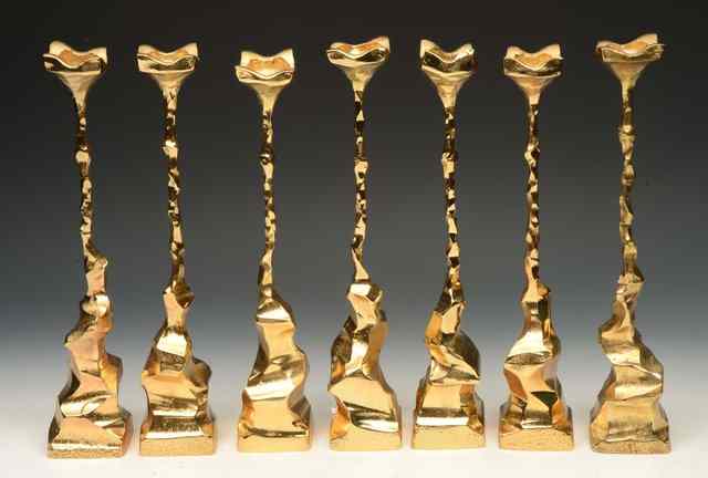 Appraisal: A SET OF SEVEN TH CENTURY GILDED METAL CANDLE HOLDERS