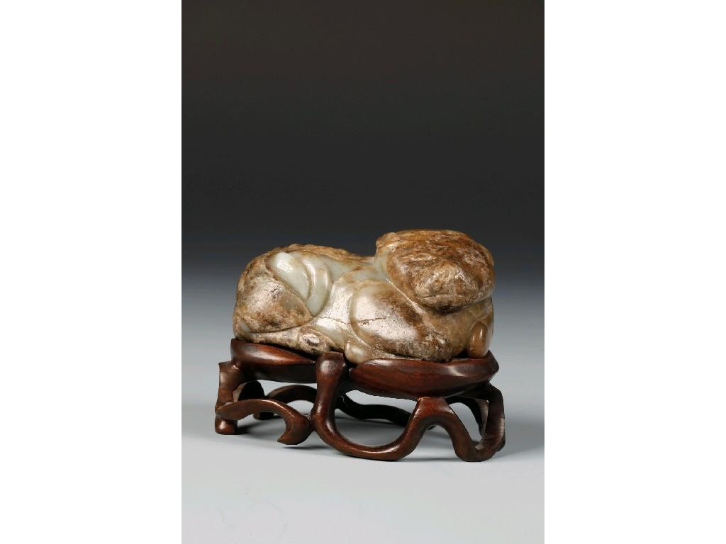 Appraisal: A CHINESE JADE OF A RECUMBENT MYTHICAL BEAST with a