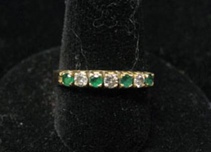 Appraisal: Emerald and diamond ring Band style has four round cut