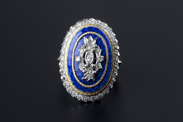 Appraisal: An enamel and diamond set panel ring the oval blue