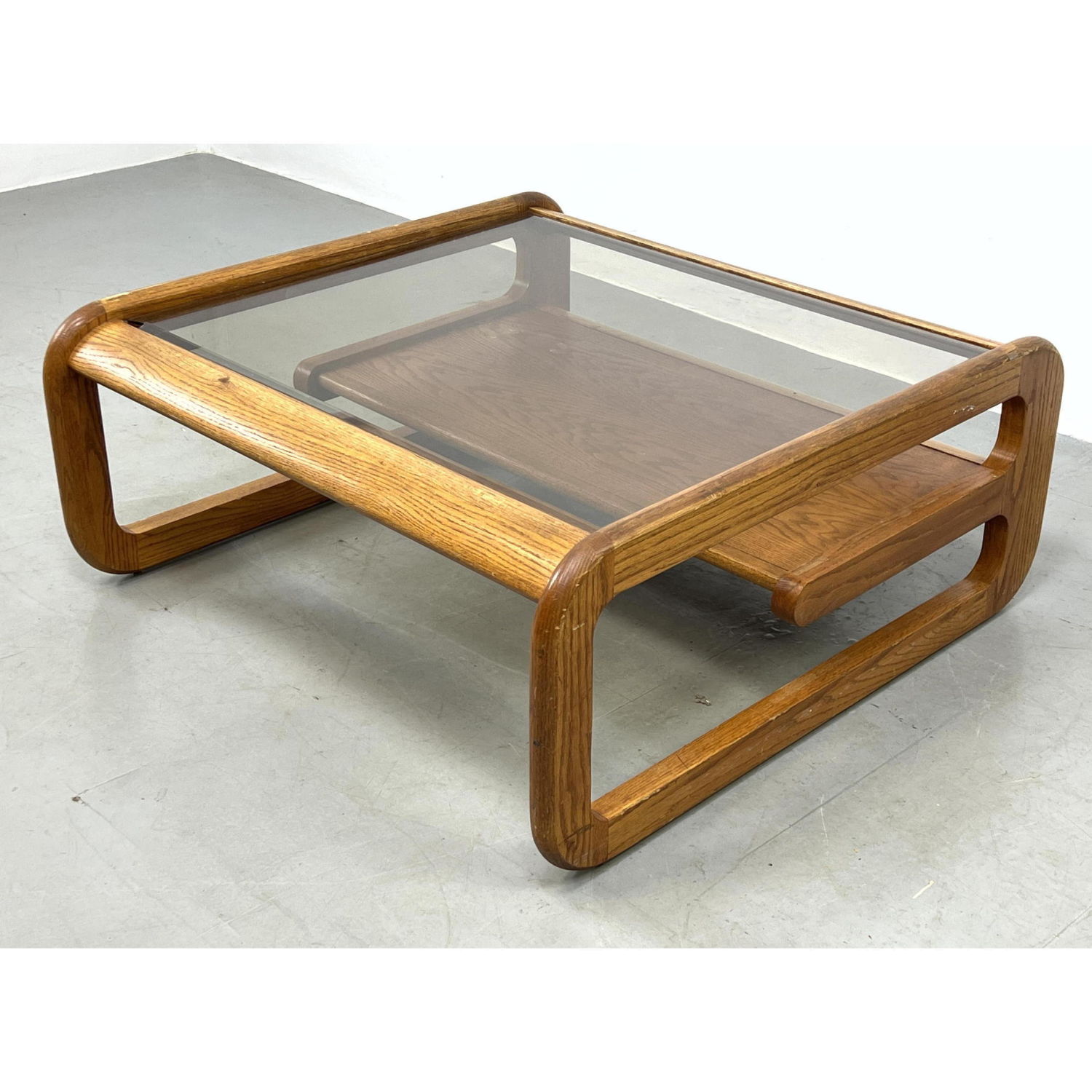 Appraisal: LOU HODGES Oak Coffee table with glass top and lower