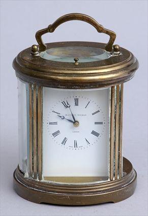 Appraisal: SWISS BRASS AND OVAL CARRIAGE CLOCK Retailed by Matthew Norman