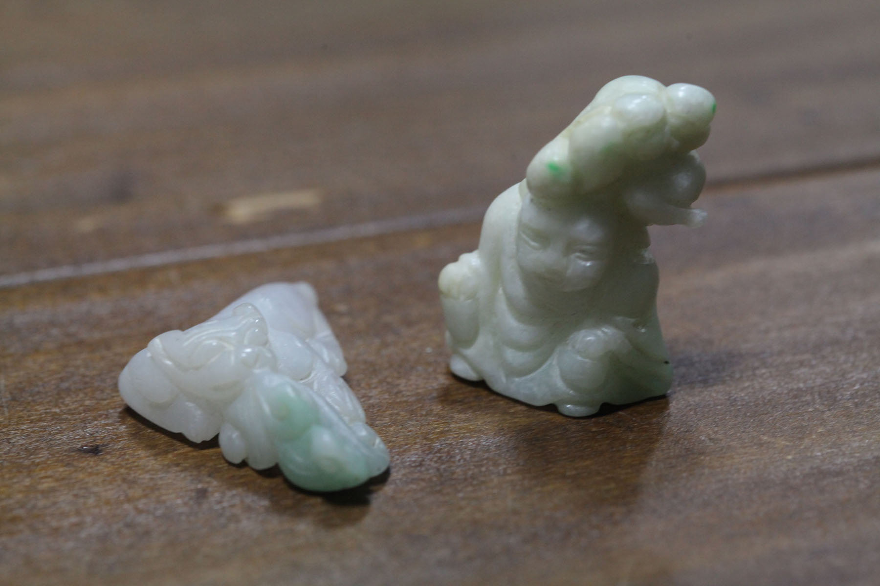 Appraisal: TWO CARVED STONES Asian th century probably jade Man in