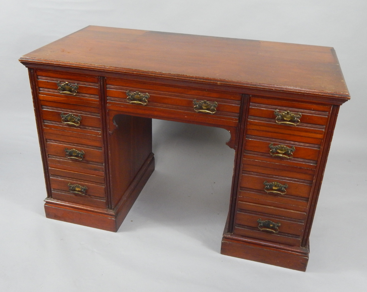 Appraisal: A Victorian walnut twin pedestal desk with one long and