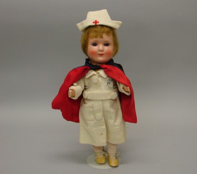 Appraisal: Germany - painted bisque type nurse doll Blue sleep eyes