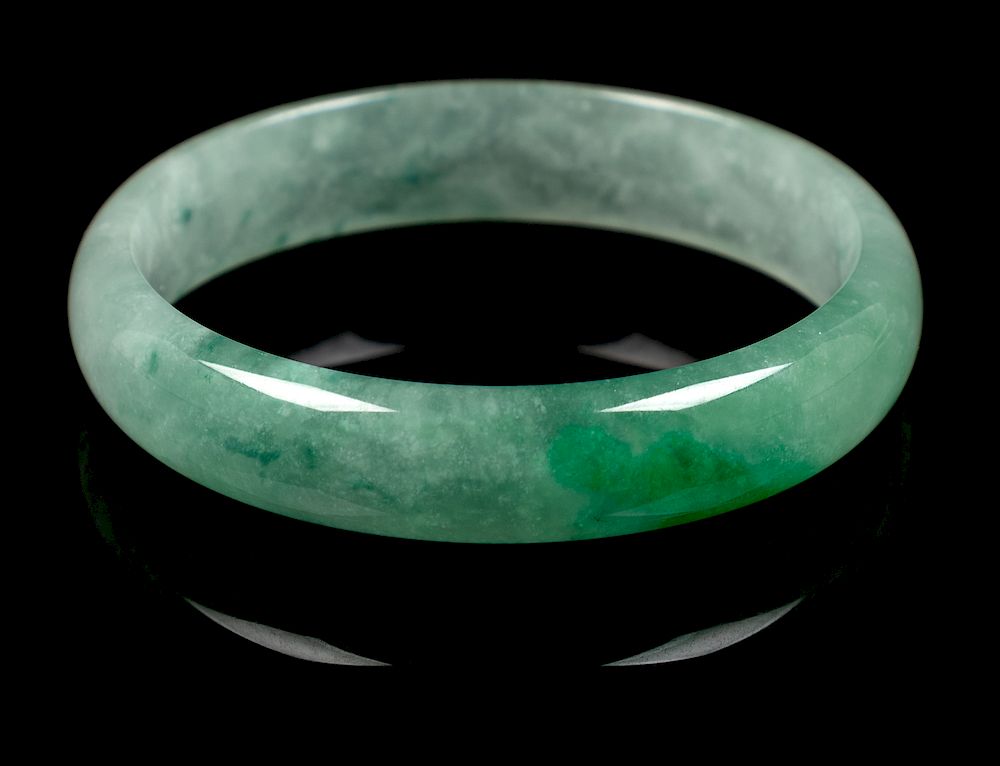 Appraisal: An Apple Green and Pale Celadon Jadeite Bangle Interior diam