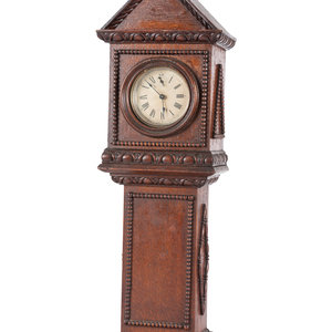 Appraisal: A Miniature Carved Tall Case Clock Western Clock Mfg Co