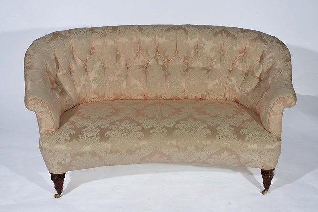 Appraisal: A LATE VICTORIAN CURVED SMALL BUTTON BACK SOFA covered in