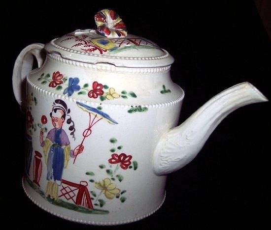 Appraisal: A creamware teapot the circular lid with floral finial above