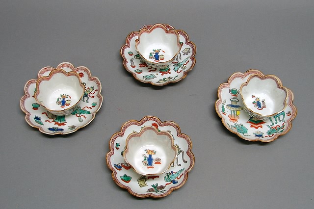 Appraisal: Scalloped borders painted with antiques designs in famille verte enamels