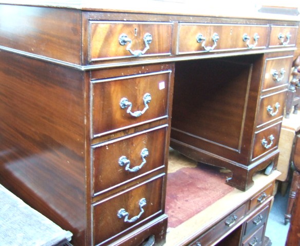 Appraisal: A th century mahogany twin pedestal desk with green leather