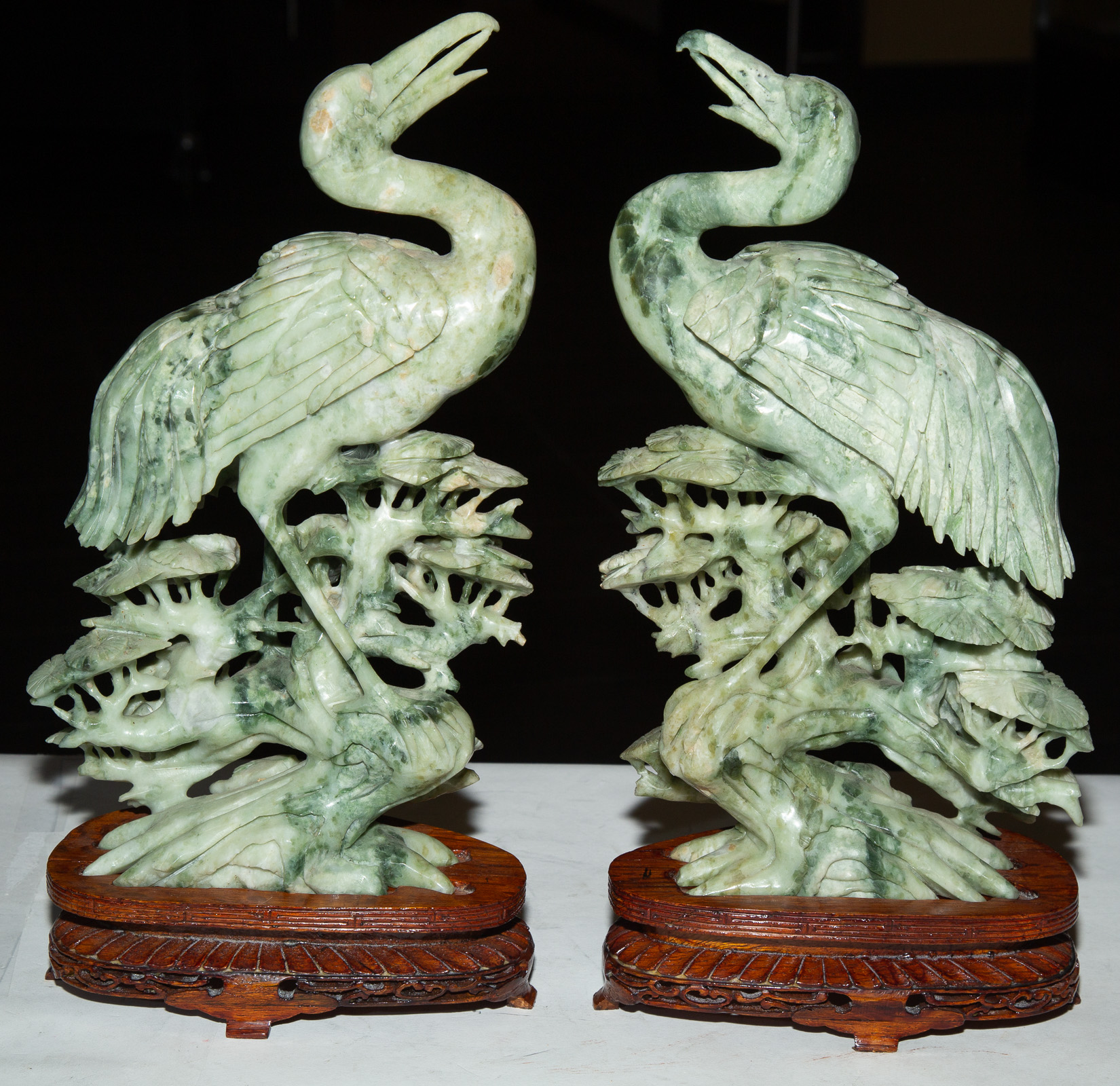 Appraisal: PAIR OF CHINESE GREEN SOAPSTONE STORK FIGURES th century with