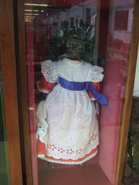 Appraisal: A black faced ceramic doll with cloth body and ceramic