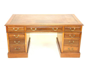 Appraisal: An Edwardian walnut pedestal desk the inset leather top above