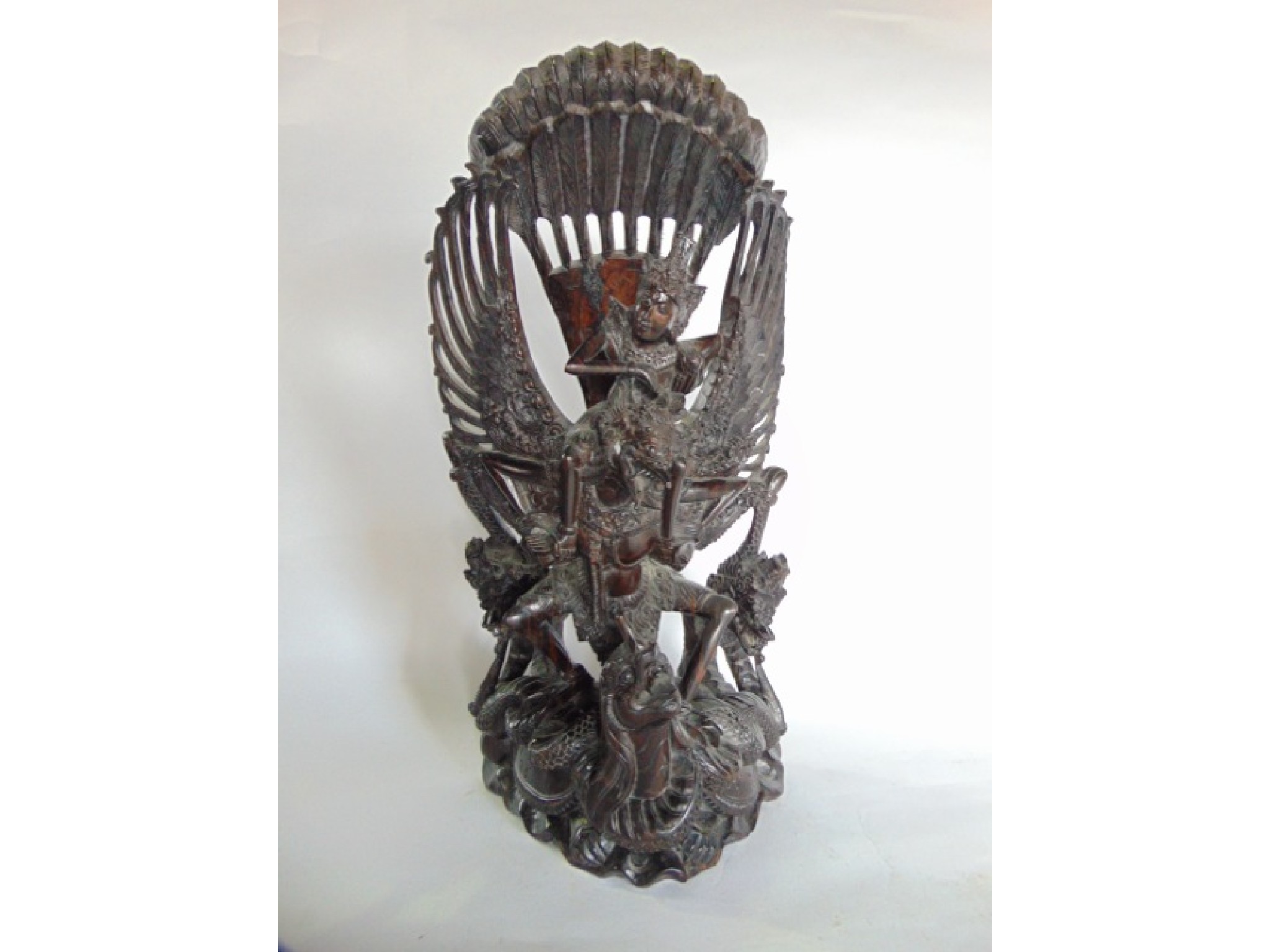 Appraisal: A highly detailed heavy carved Indonesian hardwood study of deity