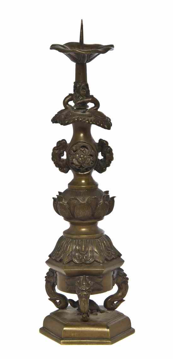 Appraisal: A Chinese Bronze Candlestick having a lotus form bobeche above