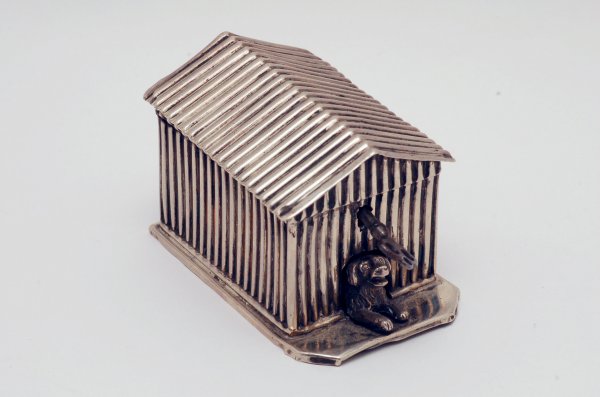 Appraisal: Silver bank in the shape of a doghouse with dog