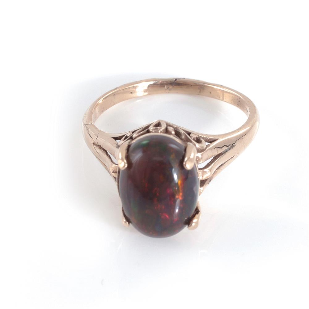 Appraisal: Black opal and gold ring x mm oval cabochon opal