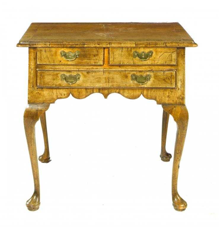 Appraisal: A WALNUT LOWBOY the quarter veneered crossbanded and moulded top