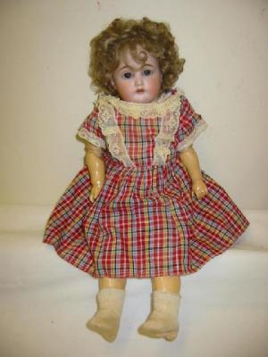 Appraisal: A bisque head character doll with blue sleeping eyes open