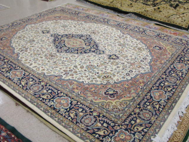 Appraisal: PAKISTANI PERSIAN CARPET floral and blue central floral medallion design