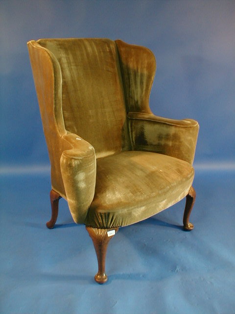 Appraisal: A thC walnut framed wing armchair in George I style