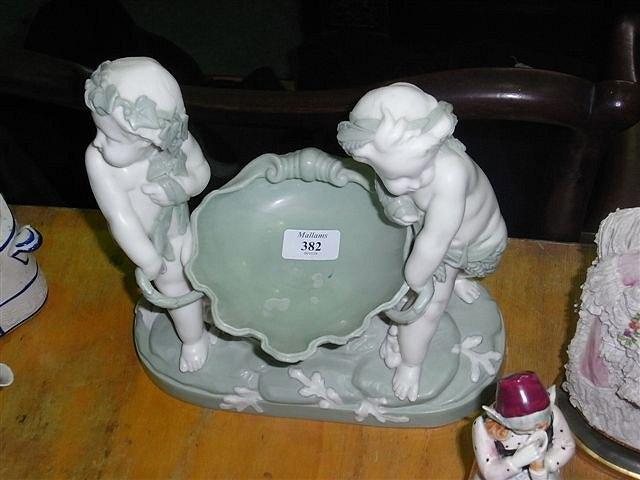 Appraisal: A MINTON PORCELAIN SHELL SWEETMEAT BASKET flanked by two cupids