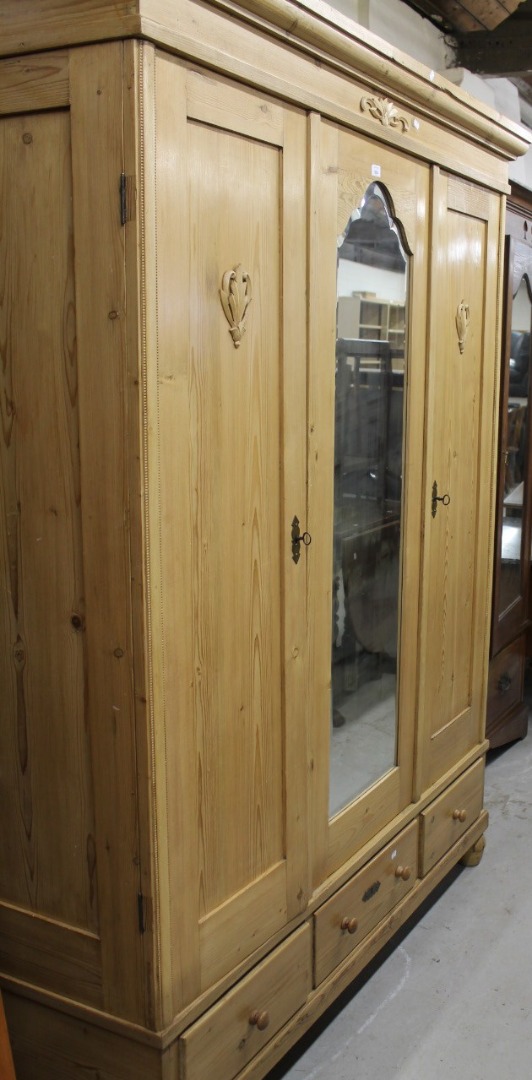 Appraisal: A stripped and lightly polished reconstituted pine double door wardrobe