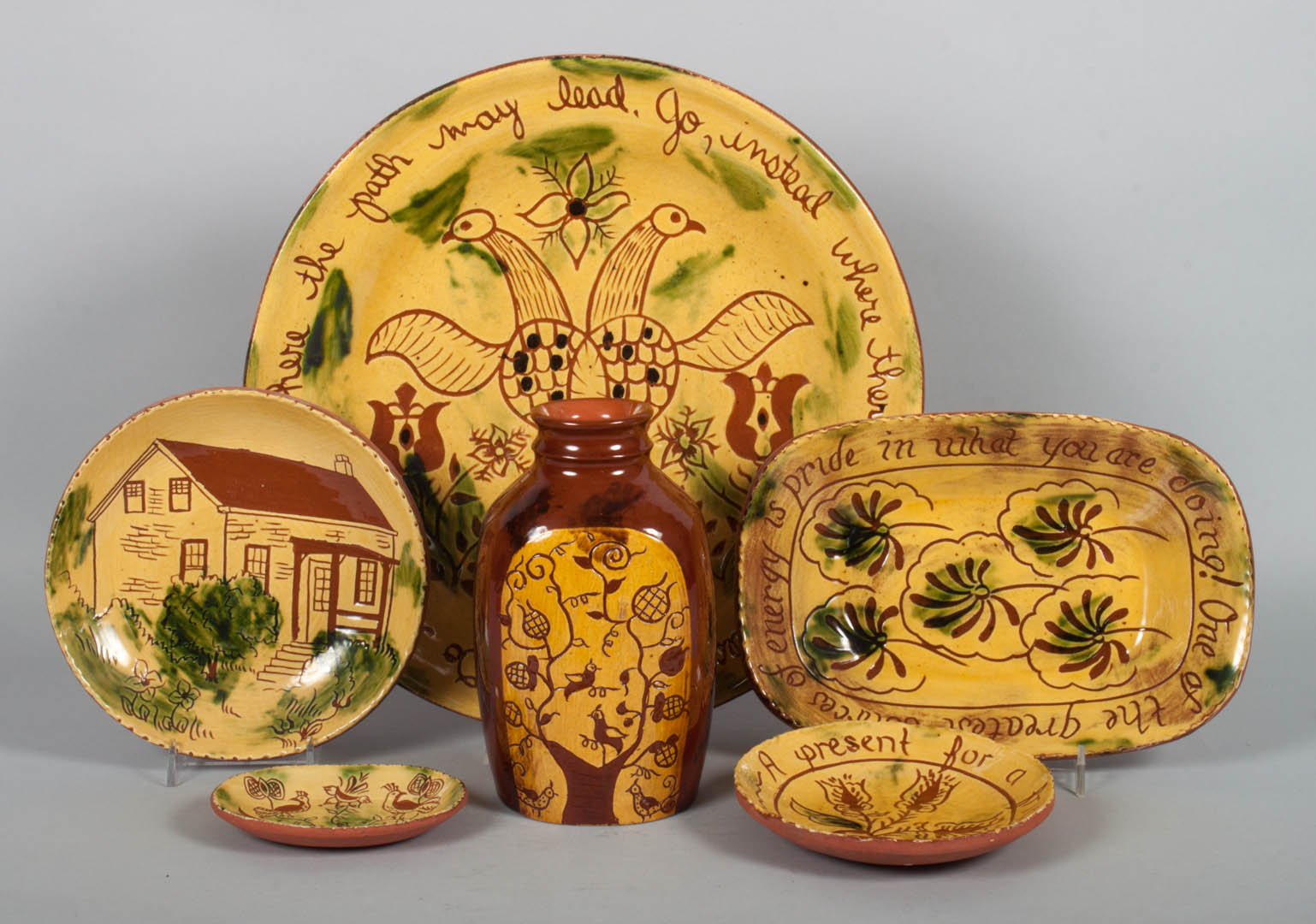 Appraisal: Assorted yellow slip-glazed redware items circa 's sgraffito decorated pieces