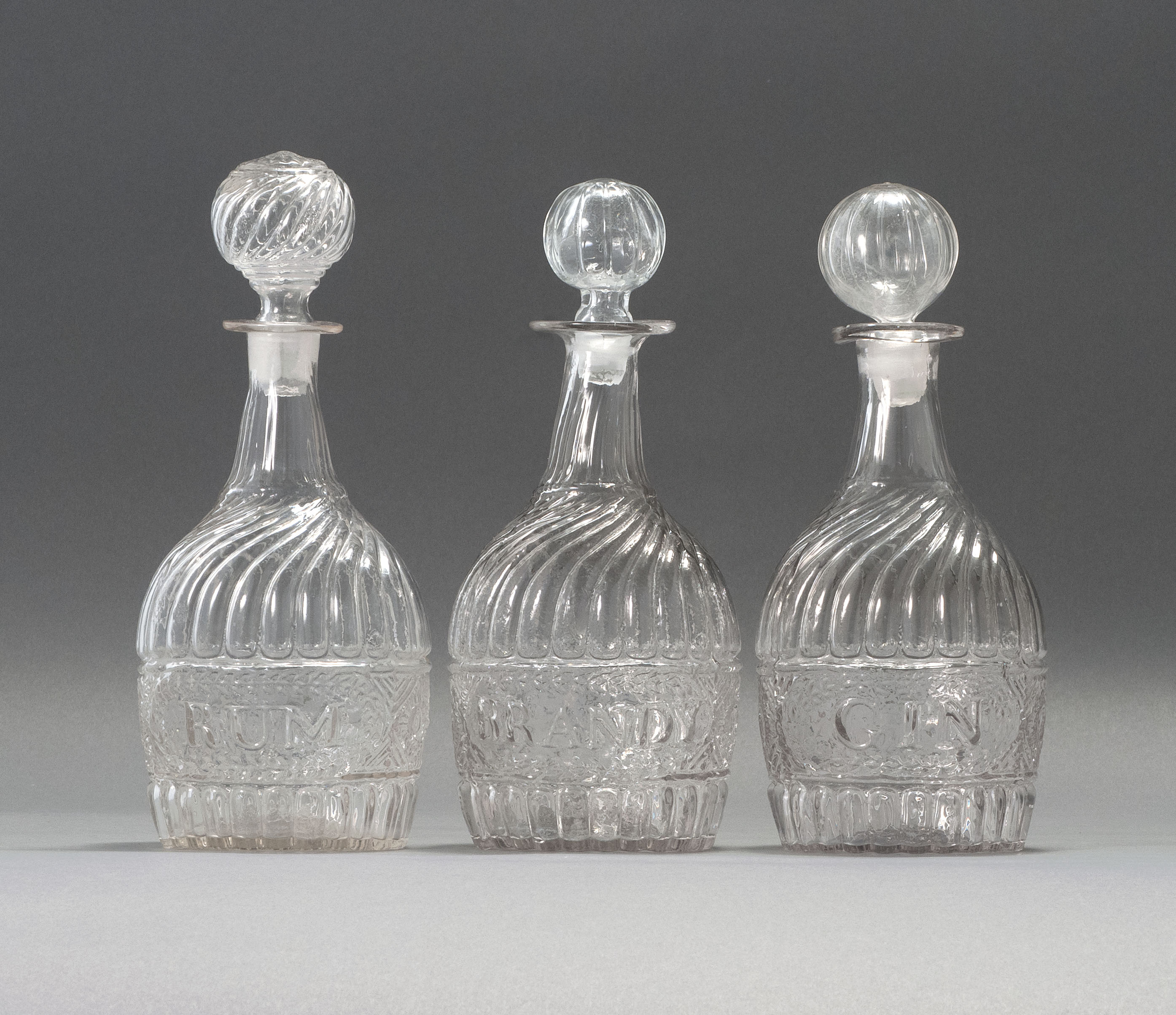 Appraisal: SET OF THREE CLEAR GLASS BLOWN -MOLD DECANTERS Second Quarter