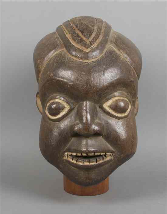 Appraisal: A Carved Helmet Mask Bamum depicting a smiling male figure