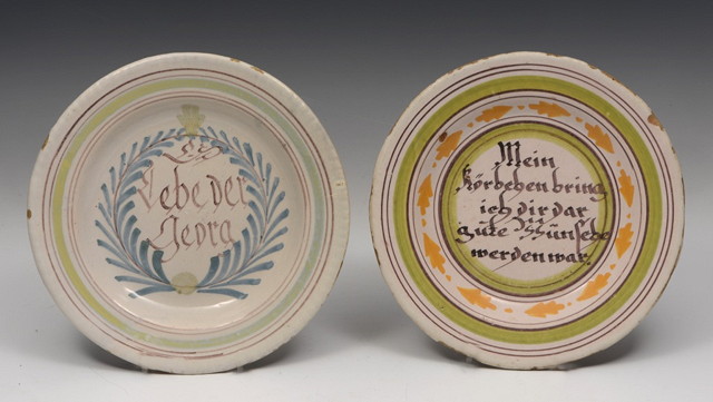 Appraisal: TWO GERMAN FAIENCE POTTERY PLATES each with an inscription in