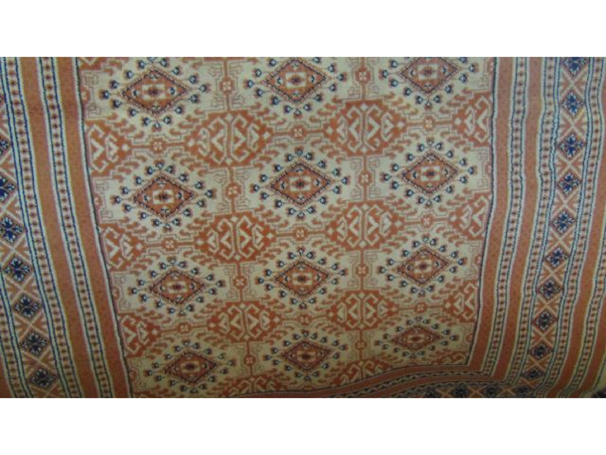 Appraisal: A cream ground eastern wool carpet with multi medallion centre