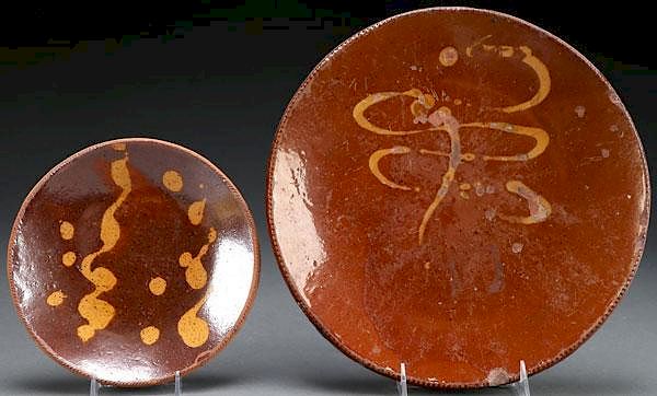 Appraisal: PENNSYLVANIA DECORATED REDWARE PLATES A PAIR OF PENNSYLVANIA SLIP DECORATED