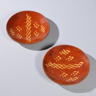 Appraisal: Two Redware Slip-decorated Plates America early th century dot and