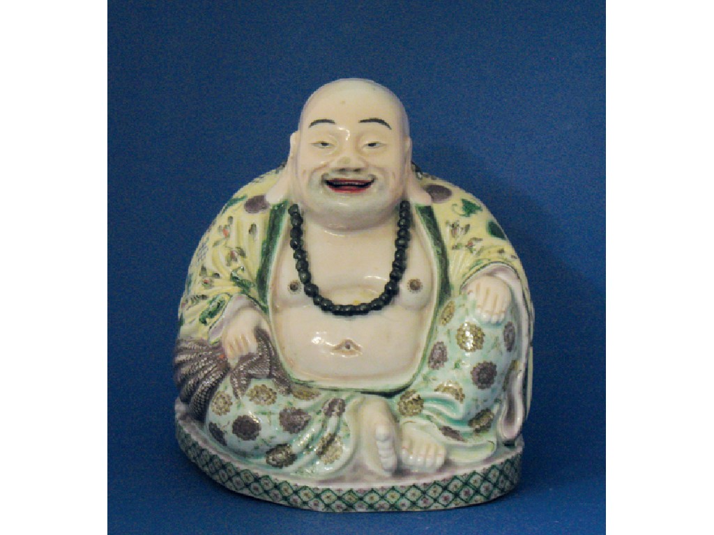 Appraisal: A CHINESE FAMILLE VERTE FIGURE of Hotei sitting on an