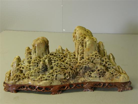 Appraisal: Chinese soap stone carving of a moutainous landscape with buildings