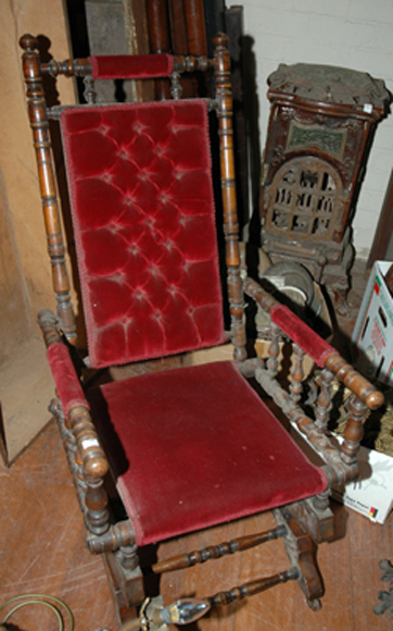 Appraisal: AN EDWARDIAN PLATFORM ROCKING CHAIR With red velvet button back