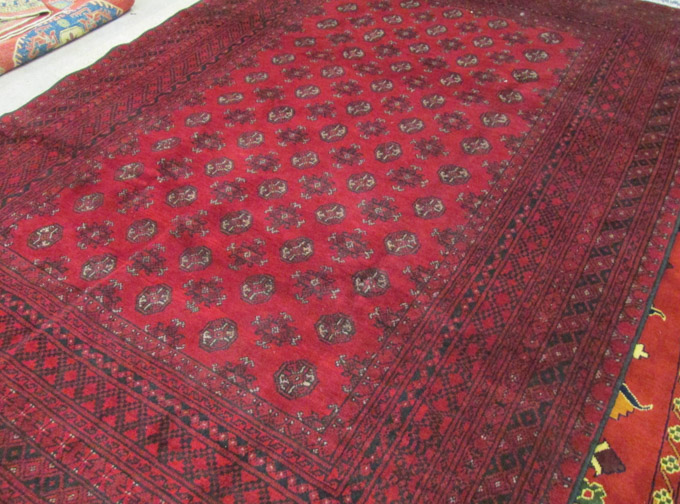 Appraisal: HAND KNOTTED ORIENTAL CARPET Afghan Bokhara featuring a field of