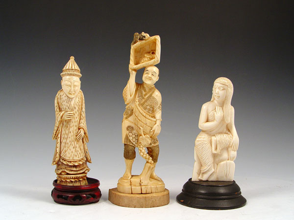 Appraisal: CHINESE CARVED IVORY FIGURES Man with basket of grapes and