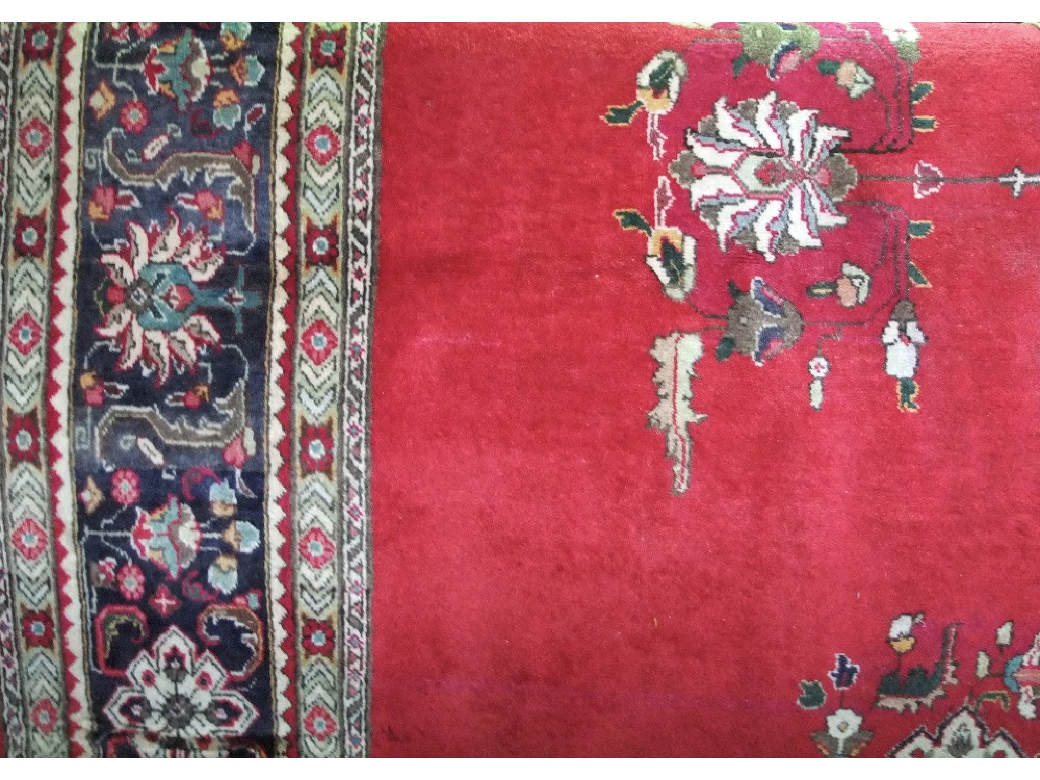 Appraisal: A large eastern style wool rug with red ground field