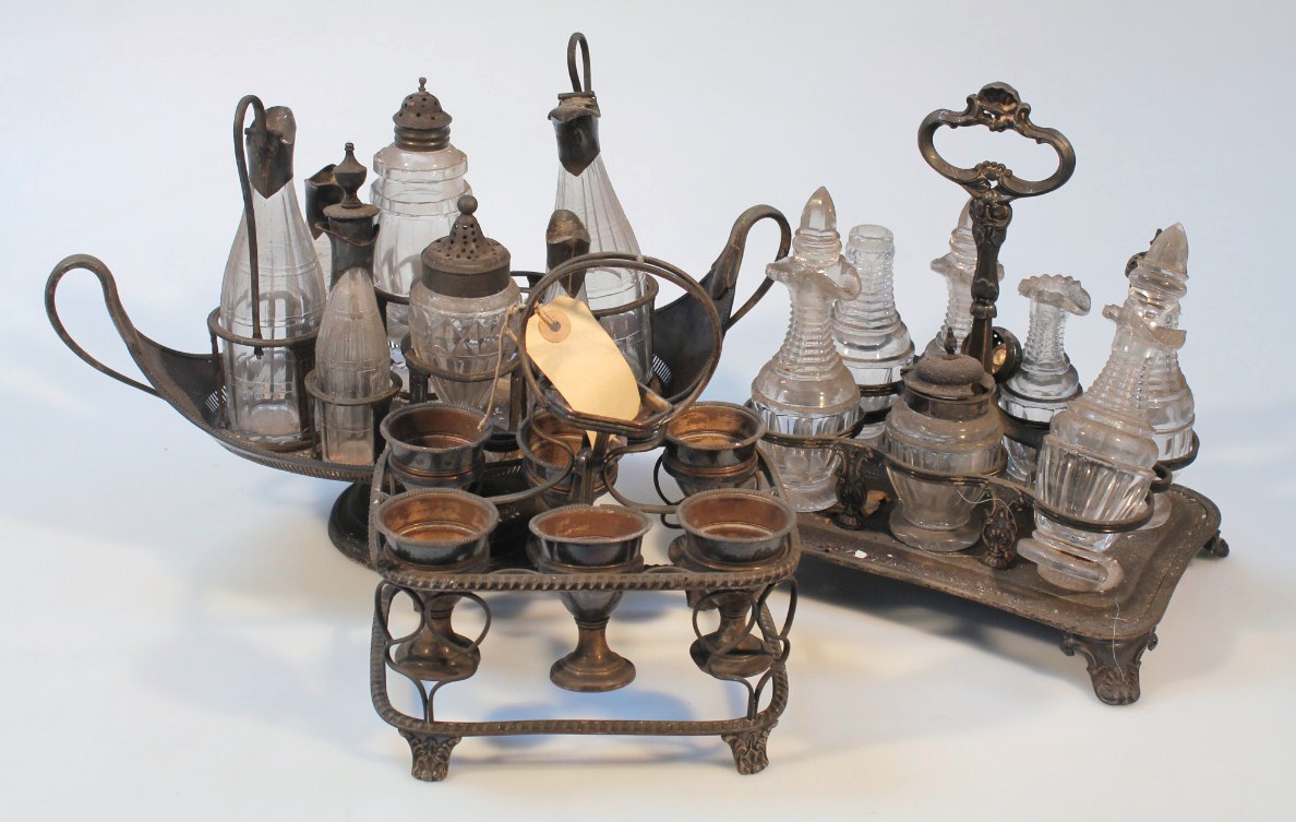 Appraisal: An Edwardian boat shaped cruet set with various glass bottles