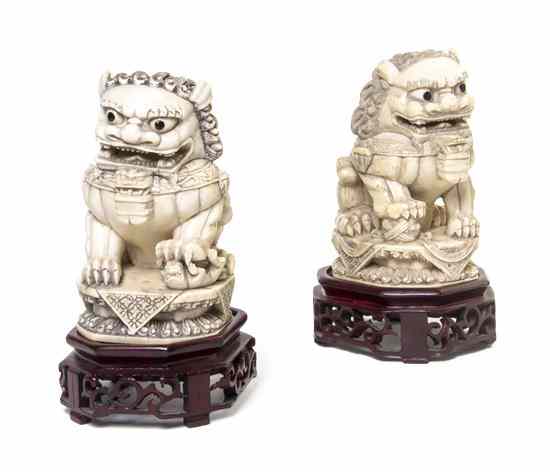 Appraisal: A Pair of Carved Ivory Fu Dogs one depicted with